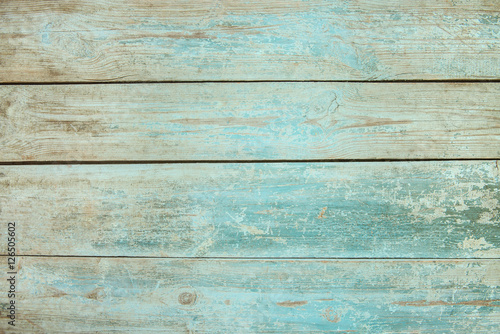 Old weathered wood plank painted in blue