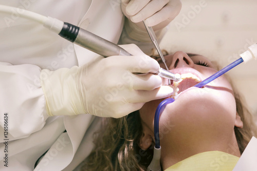 Dentist using different tools