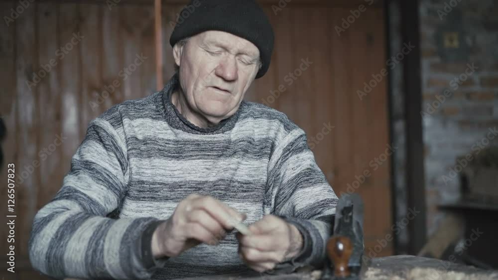 Old wrinkled man hewing handmade wooden spoon as present for wife 4K Old wrinkled man hewing handmade wooden spoon as present for wife 4K