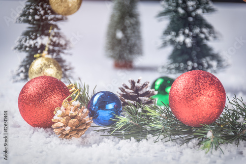 full frame of christmas ornaments on snow.