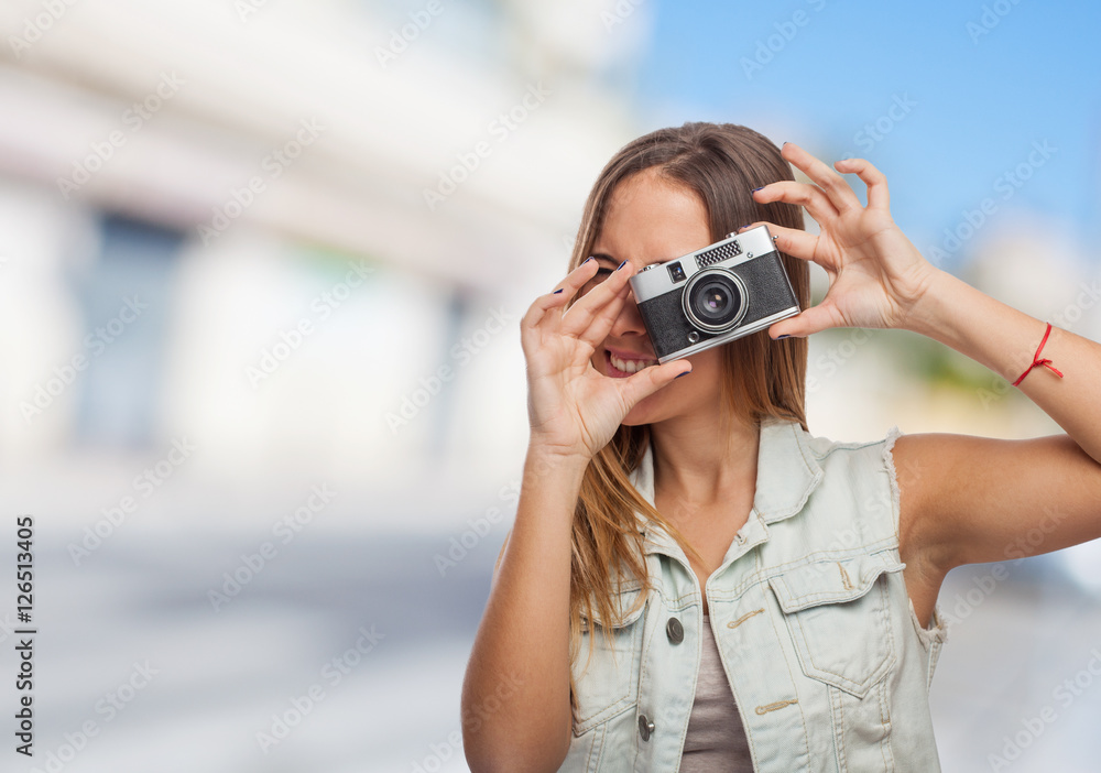 portrait of a pretty young woman taking photo with her camera