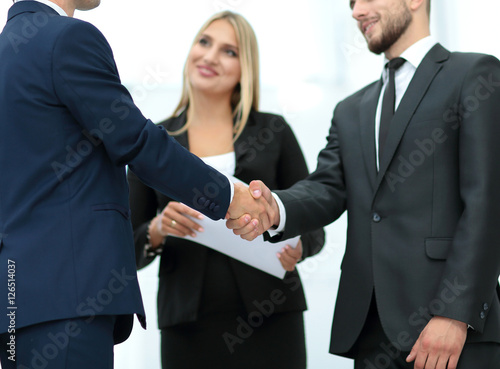 Handshake to seal a deal after a job recruitment meeting in a of