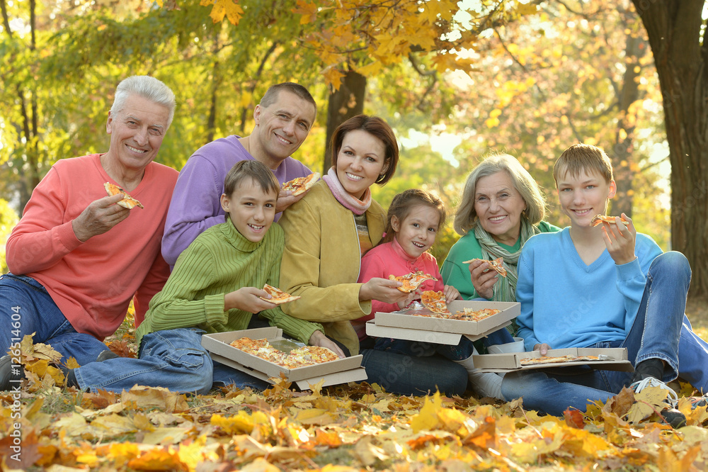 Happy family eat pizza together
