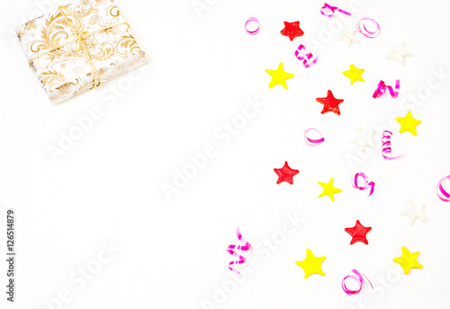 Gift with decor from stars, confetti on a white background.