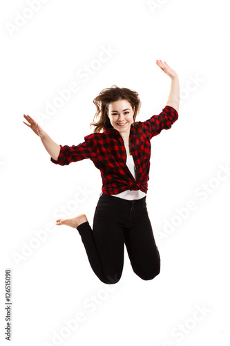 Young woman jumping on white background