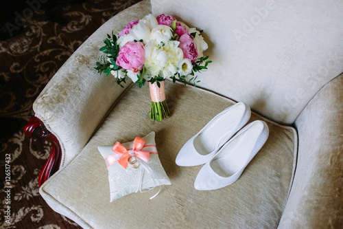 Beautiful brides wedding shoes, bouquet and wedding rings