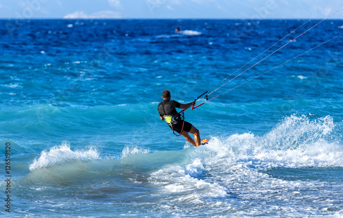 Kitesurfing, Kiteboarding action photos, man among the waves quickly goes