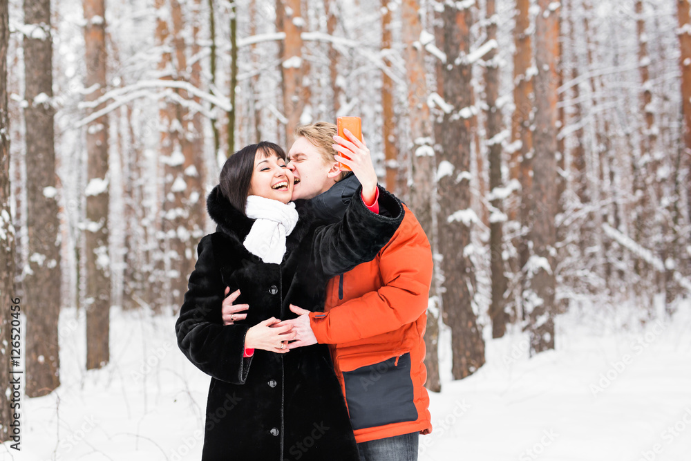 Attractive couple doing selfie outdoors.