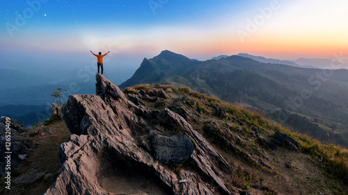 Winner man on peak of rocks mountain Hike at sunset, Active life © pongsakorn_jun26