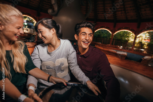 Enthusiastic people enjoying a ride at amusement park