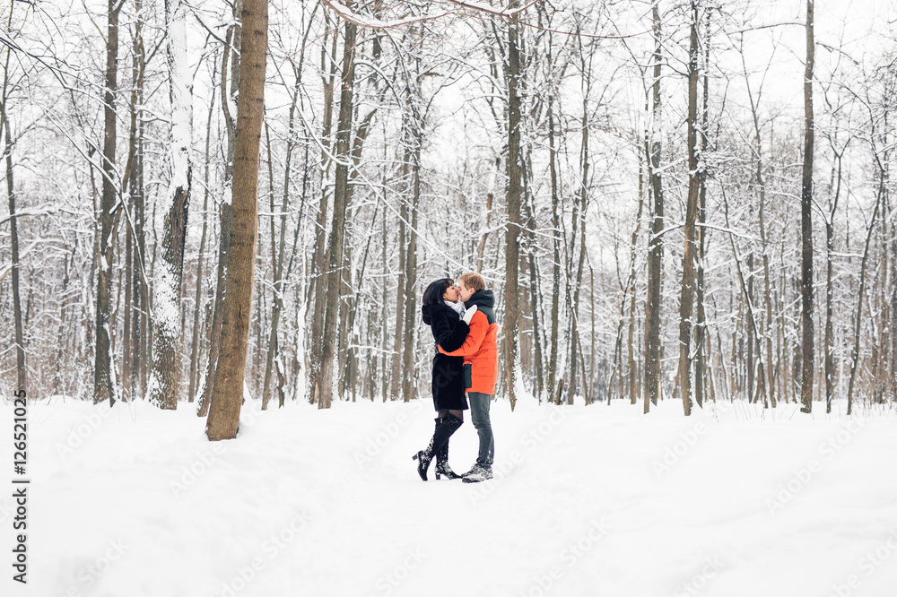 Young couple in love holding hands outdoor in winter