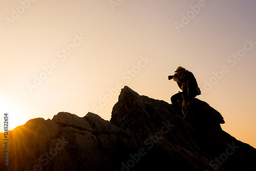 Photographer taking photos on top mountains at morning