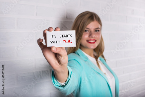 Motivational business quote. Business person in suit hold card with text photo