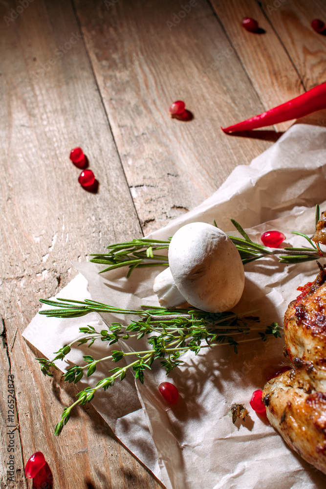 Mushrooms, red hot pepper, rosemary and berries pomegranate are on the wooden table Mushrooms, red hot pepper, rosemary and berries pomegranate are on the wooden table