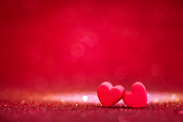 red Heart shapes on abstract light glitter background in love 