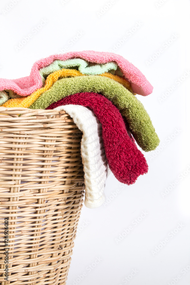 close up color mix  towel in wicker baskets on white background