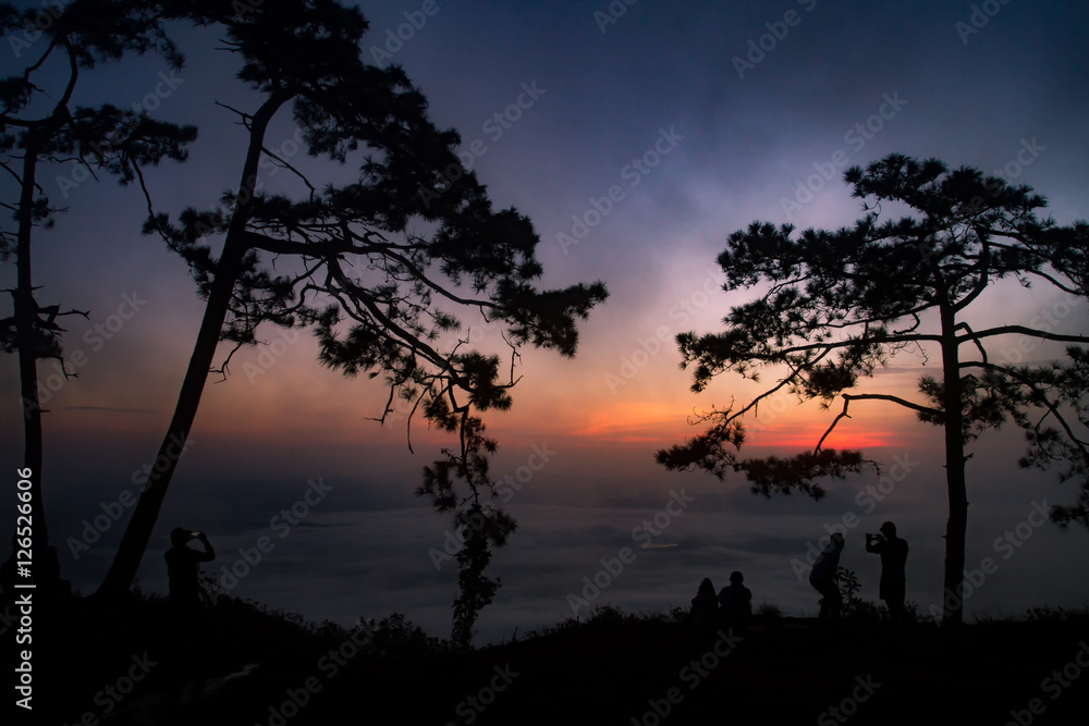 silhouette people sunrise on the mountain.