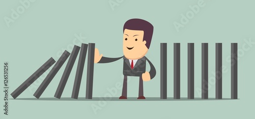Man stopping the domino effect with falling dominoes