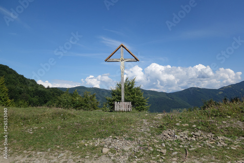 Sign of faith. Wooden cross in a cloudy sky. Mount Kobila, Transcarpathia photo