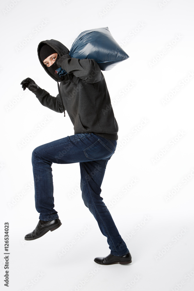 Thief in gloves with bag
