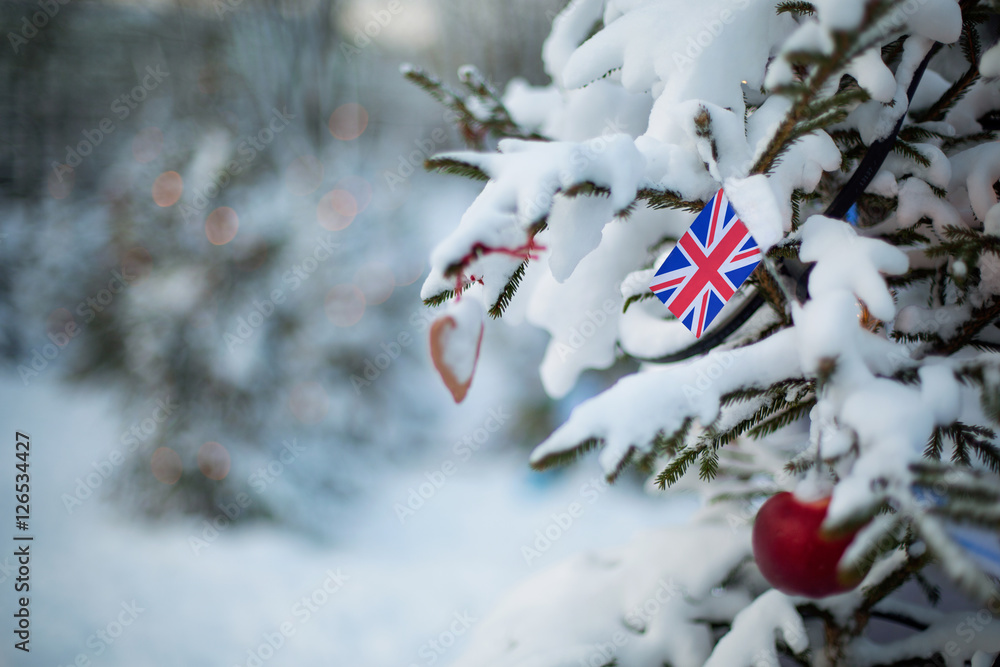 UK Christmas holiday greetings card. Christmas tree covered with snow