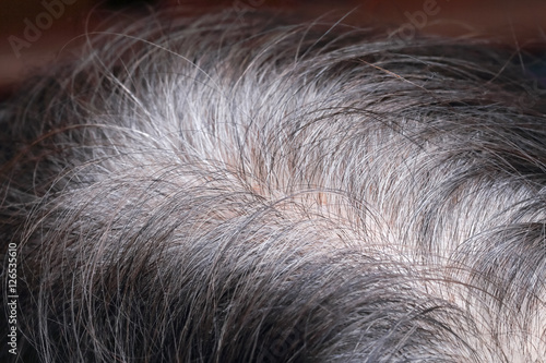 Senior asian woman shows her gray hair