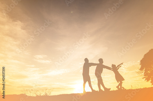 silhouette of a happy family and happy time sunset © pingdaokhaoyai