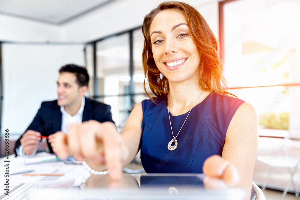 Fototapeta premium Young woman in office using tablet