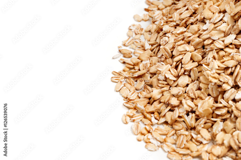 Golden oat flakes on white background. Close up, top view, high resolution product Golden oat flakes on white background. Close up, top view, high resolution product