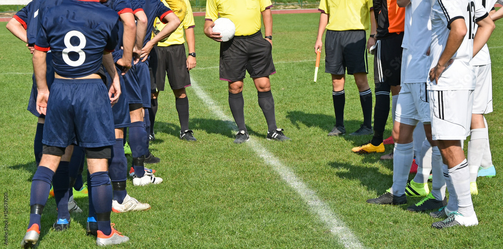 Soccer teams and referees before match Soccer teams and referees before match