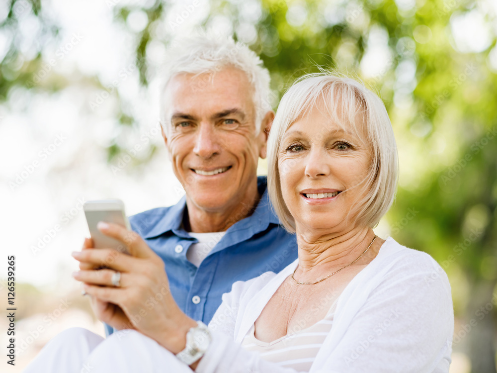 Happy senior couple looking at smartphone Happy senior couple looking at smartphone