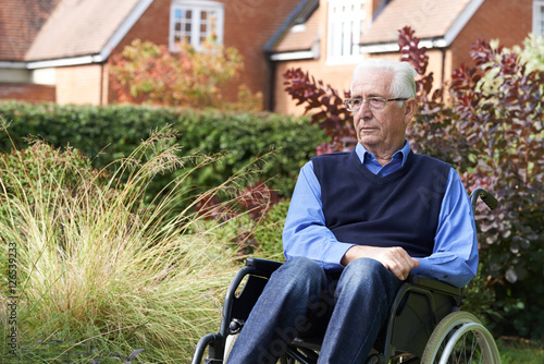 Tableau sur toile Depressed Senior Man Sitting Outdoors In Wheelchair