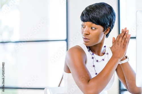 Free Download Young businesswoman sitting at desk and working - GFXLoad