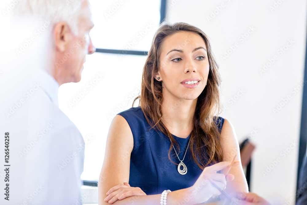Young businesswoman sitting at desk and working Young businesswoman sitting at desk and working