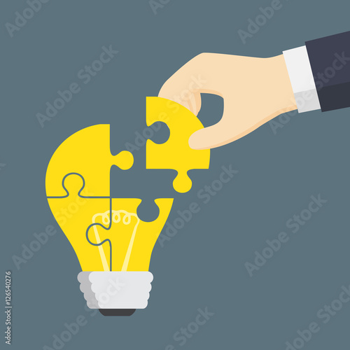People Hand Put A Part Of Light Bulb Puzzle