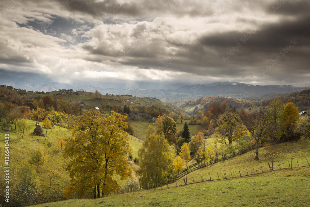 Autumn landscape hills in Romania County, traditional village