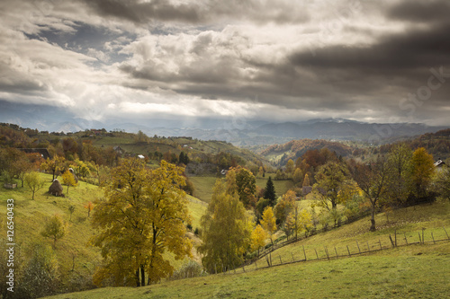 Autumn landscape hills in Romania County, traditional village © danmir12