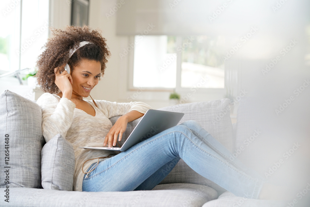 Cheerful woman making a videocall on laptop computer Cheerful woman making a videocall on laptop computer