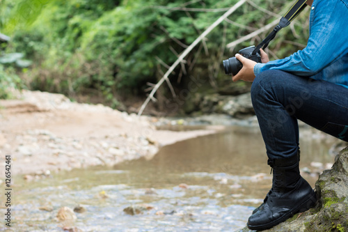 Man is hiking outdoor with river and take picture concept Lifest