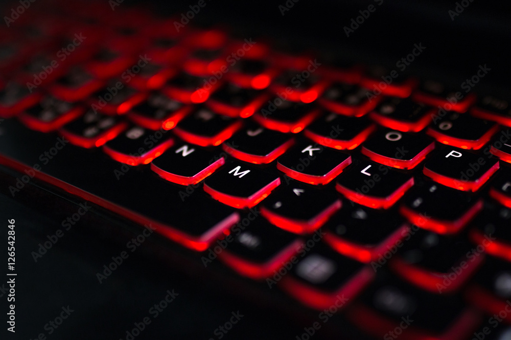Close up. Red backlight, backlit on laptop computer or keyborad computer of gaming in the dark. Concept computer keyboard background. Close up. Red backlight, backlit on laptop computer or keyborad computer of gaming in the dark. Concept computer keyboard background.