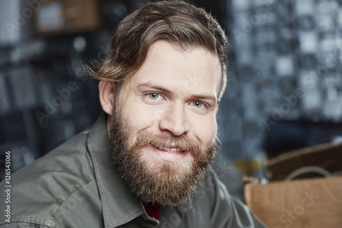 Portrait of a young man working in computer recycling plant photo