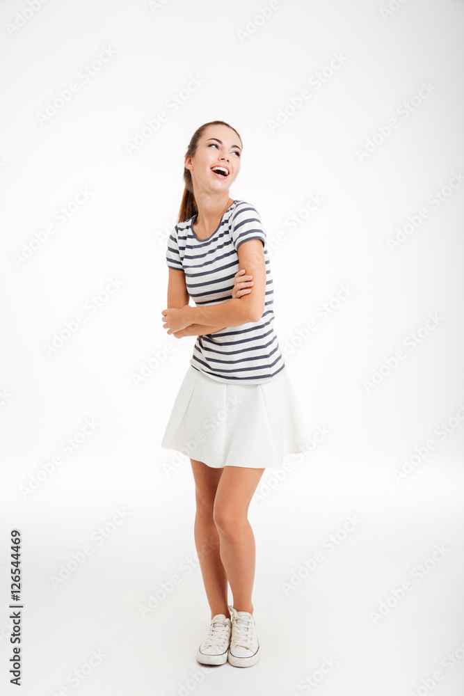 Full length portrait of a woman standing with arms folded Full length portrait of a woman standing with arms folded