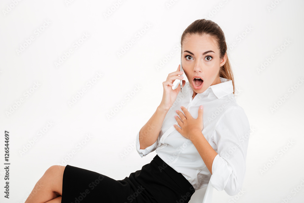 Surprised young businesswoman talking on the mobile phone Surprised young businesswoman talking on the mobile phone