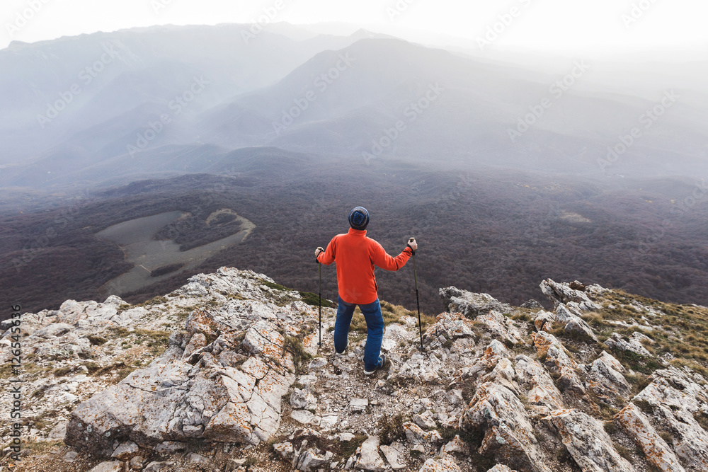 Man standing on top of rock and looking at the silhouettes of th