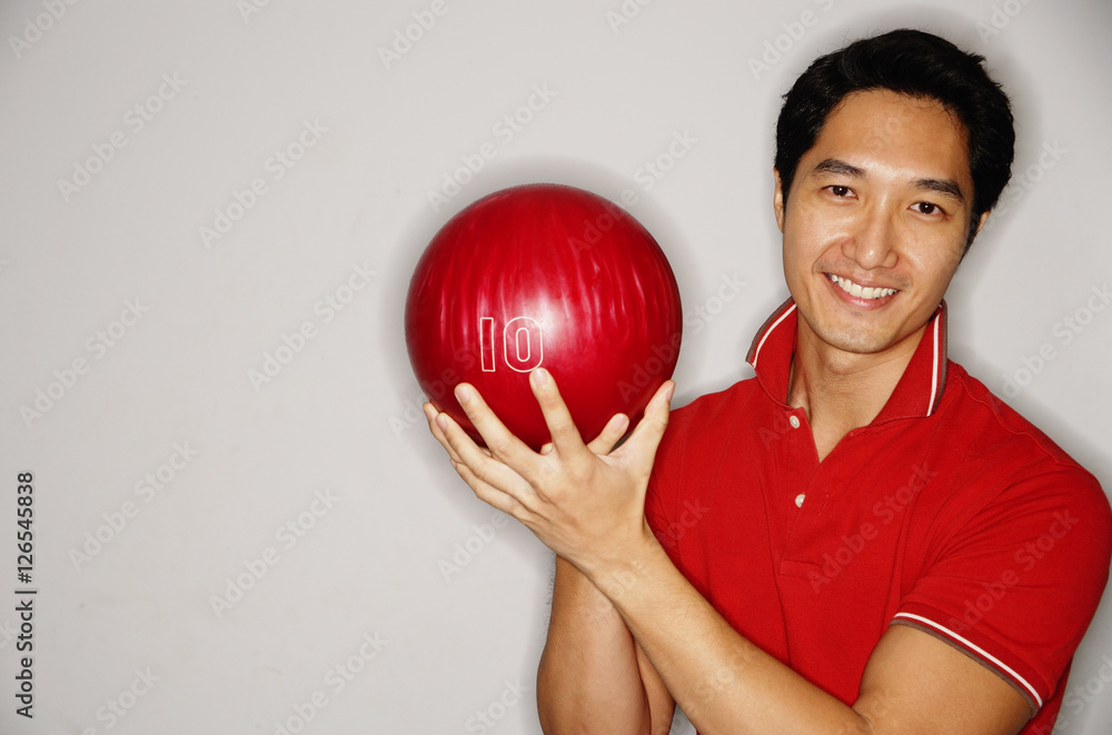 Man smiling at camera, holding bowling ball Man smiling at camera, holding bowling ball