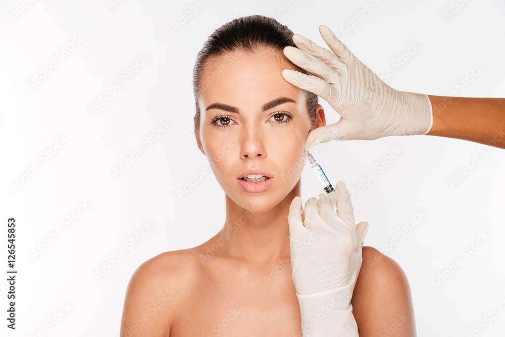 Beautiful woman gets an injection in her face Beautiful woman gets an injection in her face