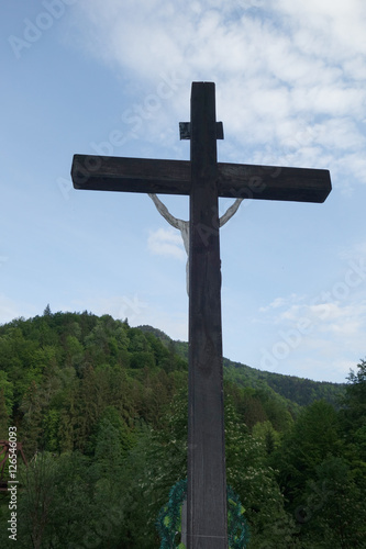 Sign of faith. Wooden cross in a cloudy sky