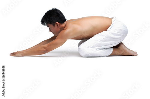 Man kneeling on floor in yoga position