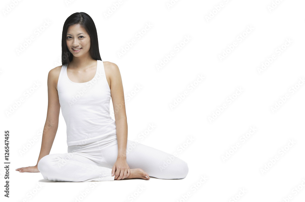 Woman sitting on floor, looking at camera, smiling Woman sitting on floor, looking at camera, smiling