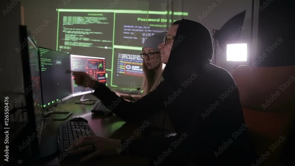 Team of hackers, hacking computers, working in dark room. HD Team of hackers, hacking computers, working in dark room. HD